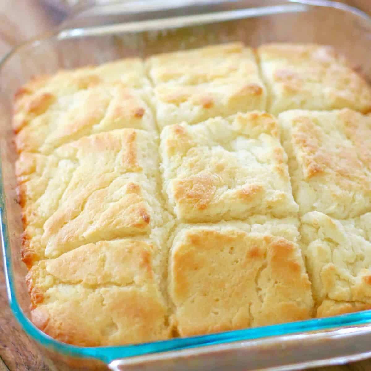 Easy Butter Dip Buttermilk Biscuits recipe - biscuits shown fully baked in a square baking dish.