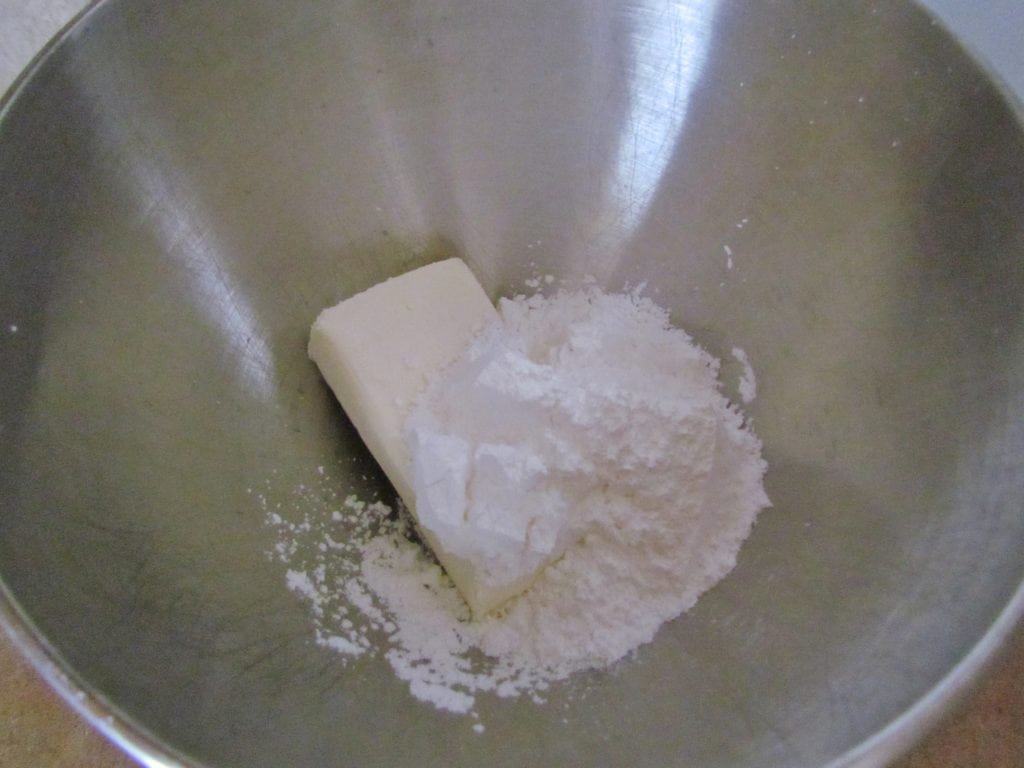 powdered sugar and cream cheese mixed together by an electric mixer