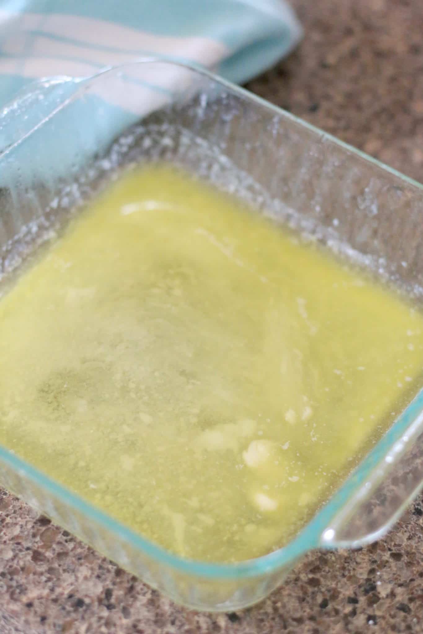 melted salted butter in square Pyrex dish.