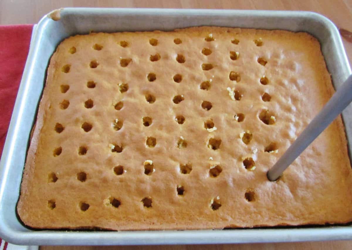 fully baked cake with holes poked in it.
