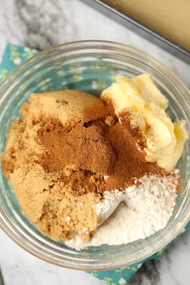 brown sugar, cinnamon, butter, flour shown in a small glass bowl.