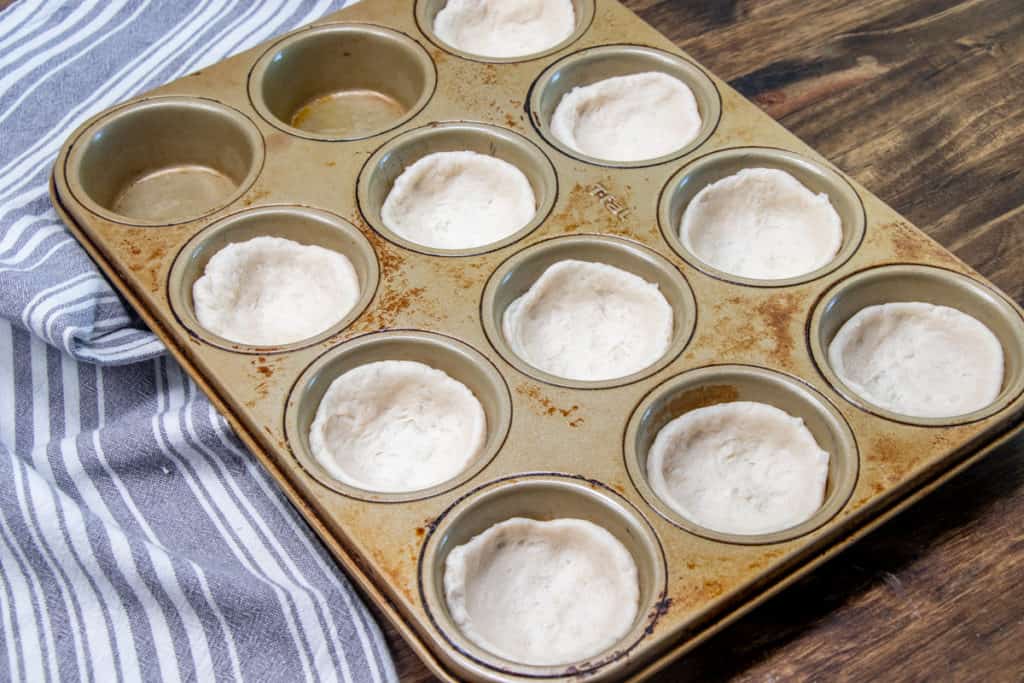 biscuits added to muffin tin.