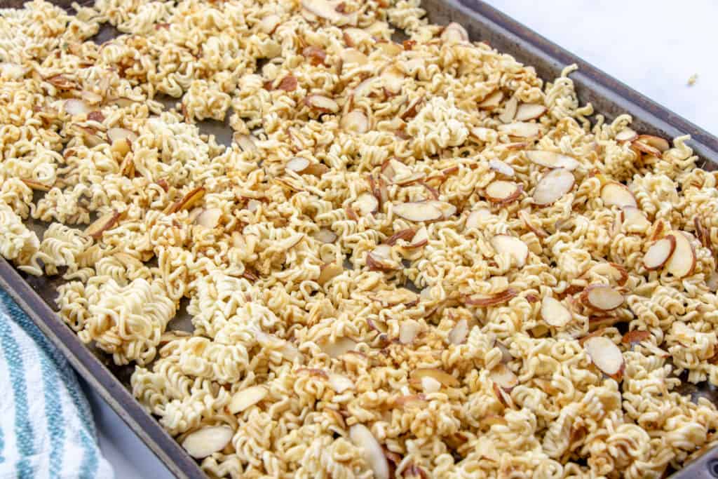 toasted ramen noodles and almonds on a baking sheet
