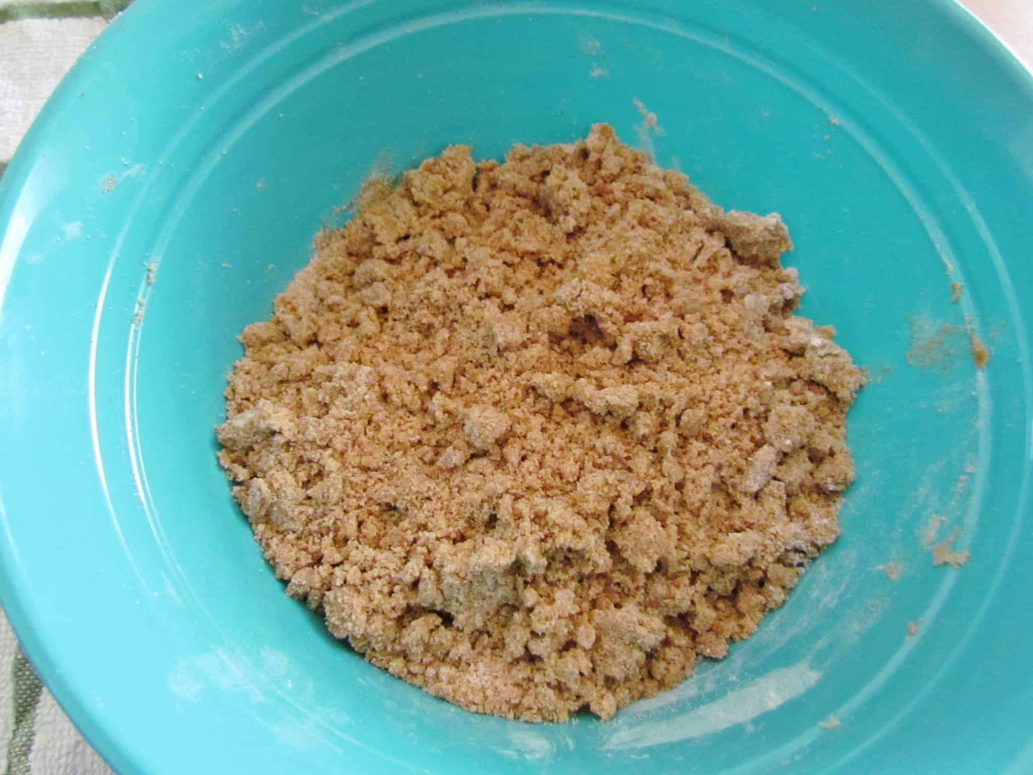 fully mixed brown sugar crumble in a blue bowl.