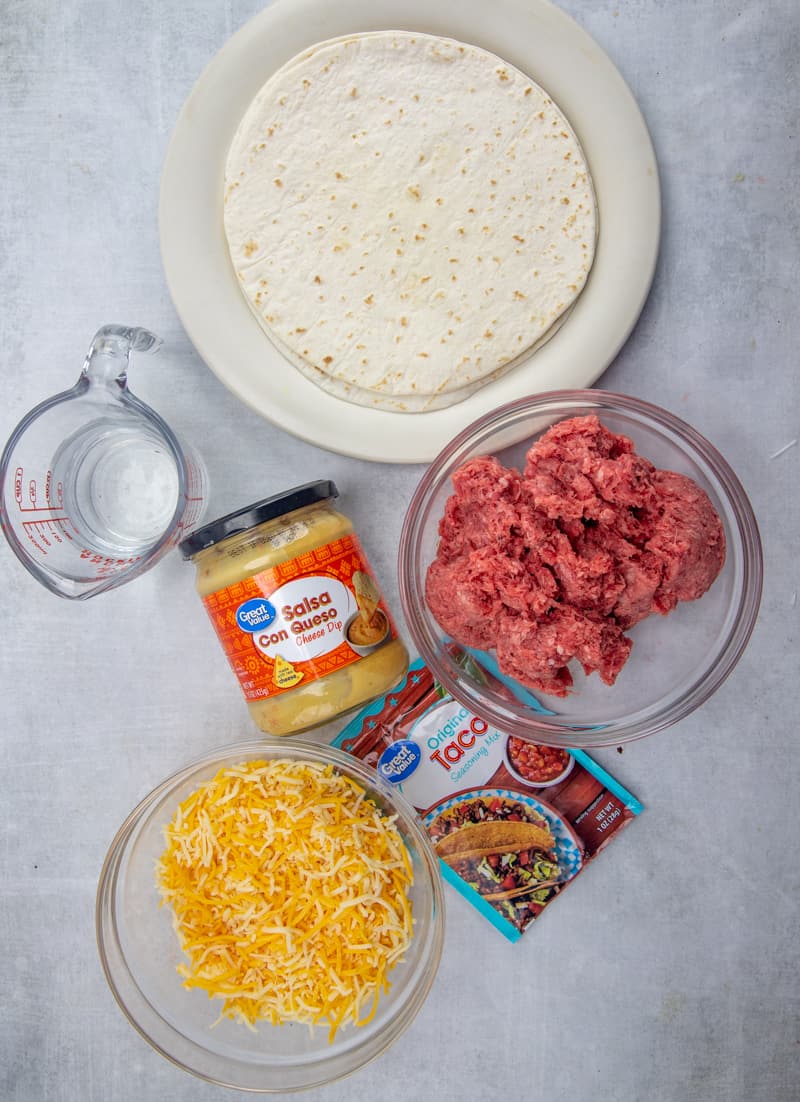 ground beef, taco seasoning, water, flour tortillas (8-inch size), mild salsa con queso, shredded Mexican cheese blend.