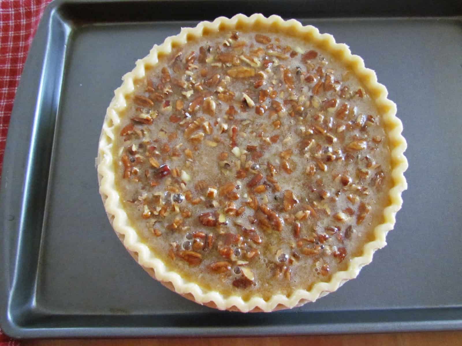 uncooked pecan pie on a baking sheet