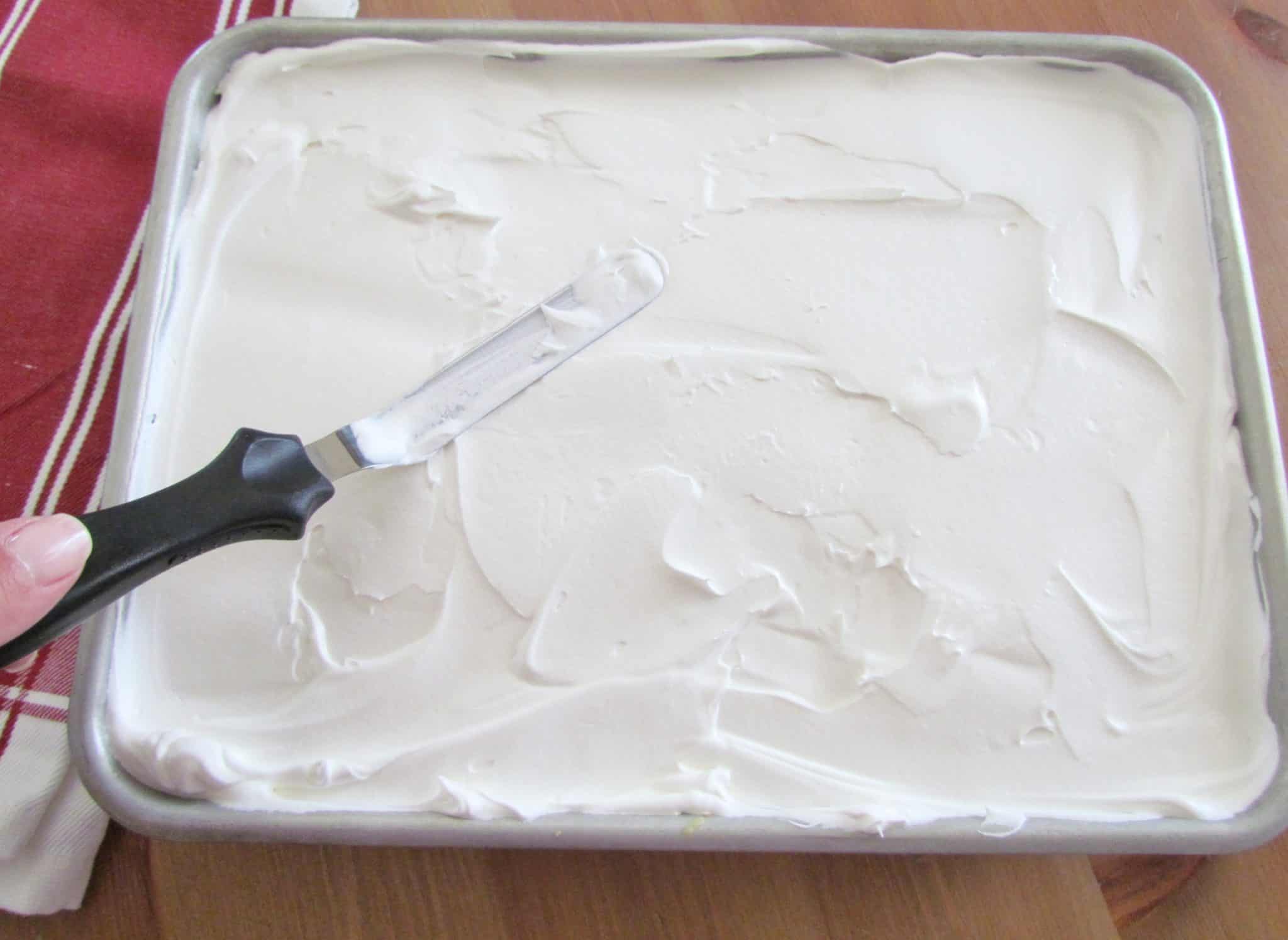 spread whipped topping (Cool Whip) on top of cooled cake.