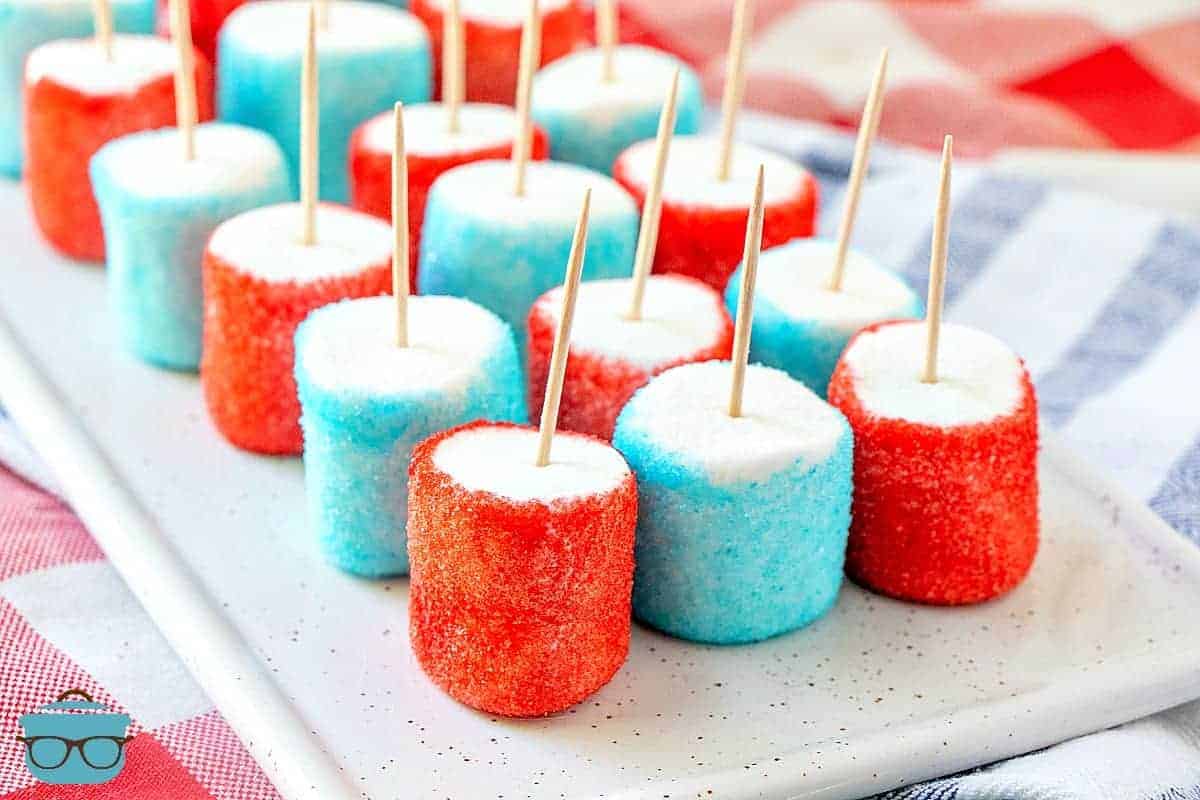 Patriotic Jell-O Marshmallows with toothpicks on a plate.