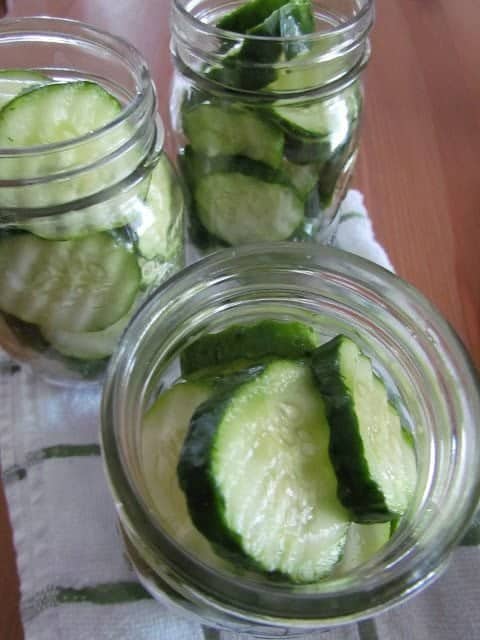 mason jars filled with sliced cucumbers