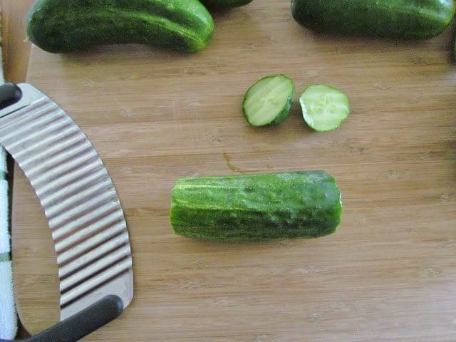 sliced cucumbers on a cutting board.