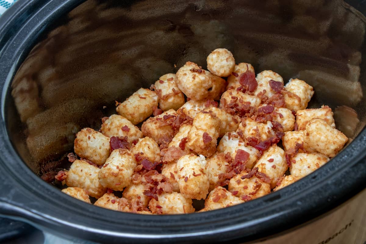 sprinkled bacon pieces on top of tater tots.