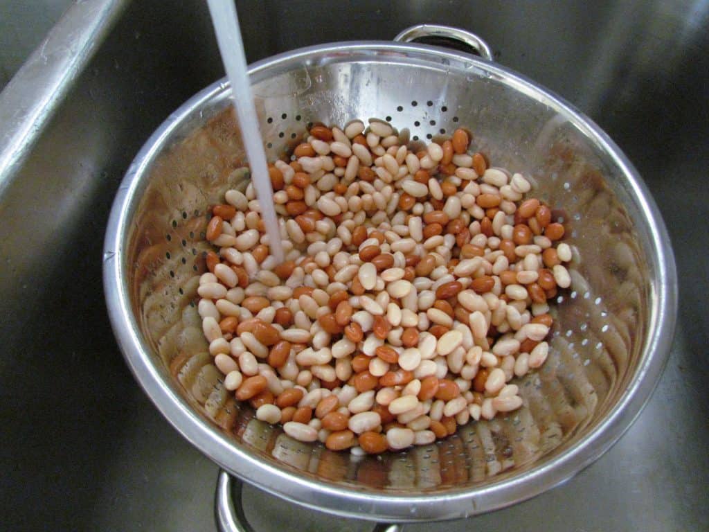 rinsing beans in a collander.