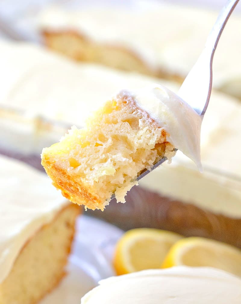 a fork holding up a bite of lemon dream cake.