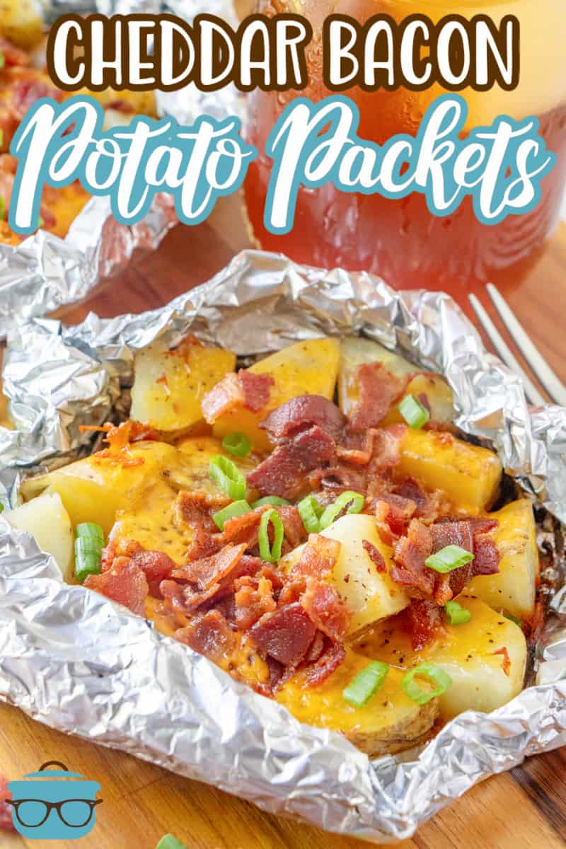 Cheddar Bacon Potato Foil Campfire Packets recipe from The Country Cook, potatoes, bacon and cheese shown in a packet of aluminum foil.