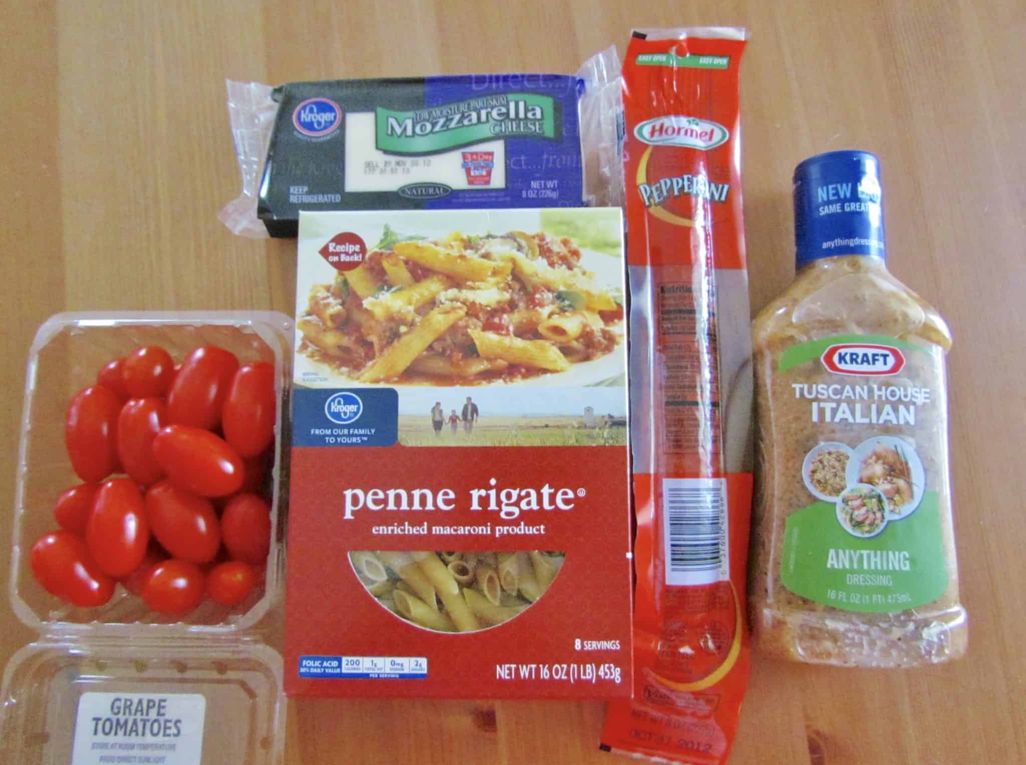 penne pasta, Italian dressing, pepperoni, mozzarella, grape tomatoes, Parmesan cheese.