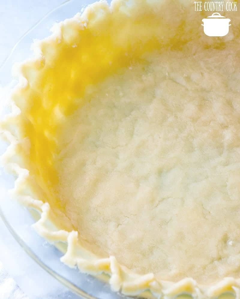 unbaked pie crust in a Pyrex pie pan.