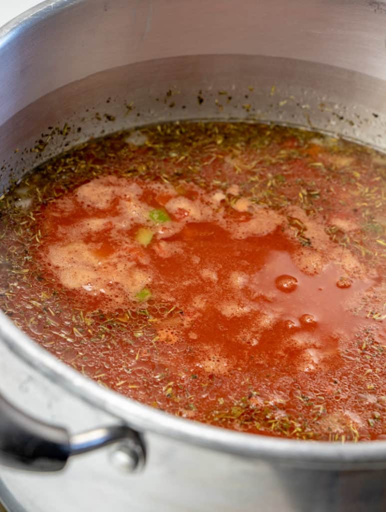 chicken broth, seasonings, ground beef, and diced tomatoes in a large pot. 