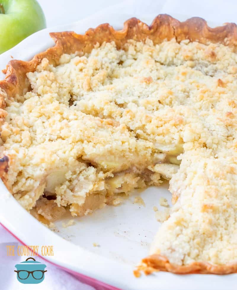 Homemade Apple Pie with Streusel Topping. Whole pie shown with one slice removed.