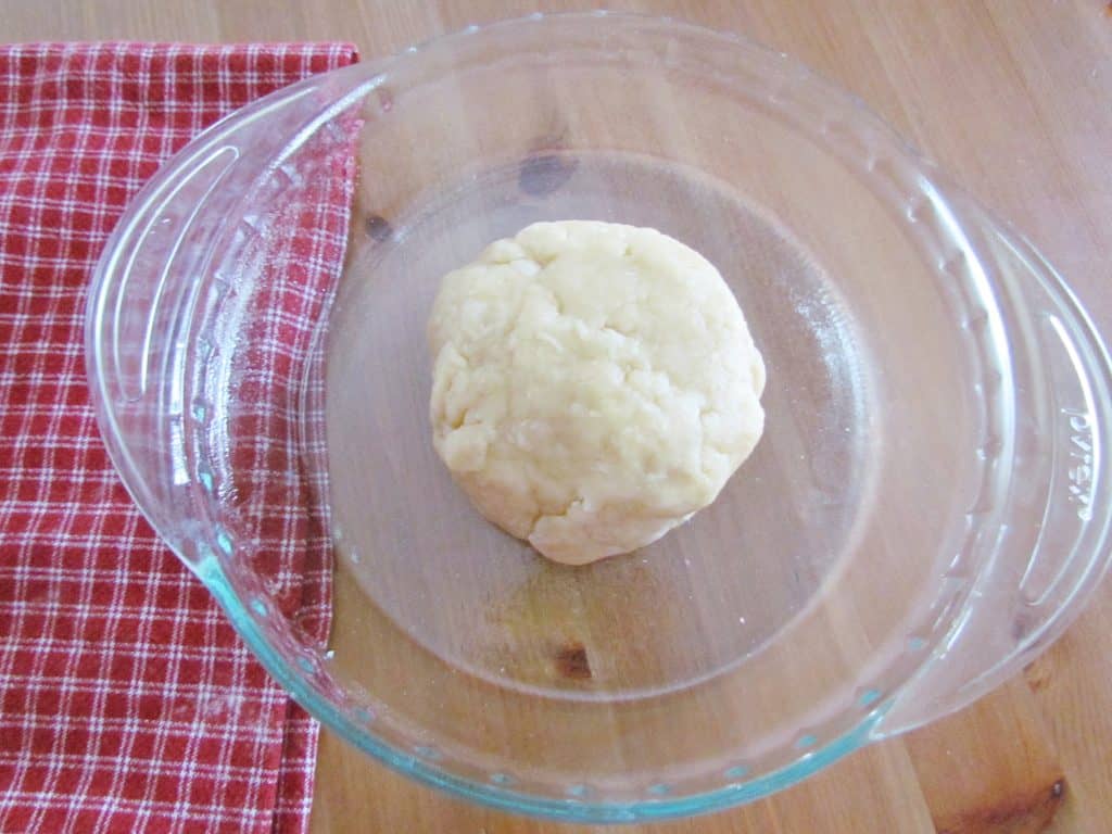 easy homemade pie crust rolled into a bowl placed into a pie pan.
