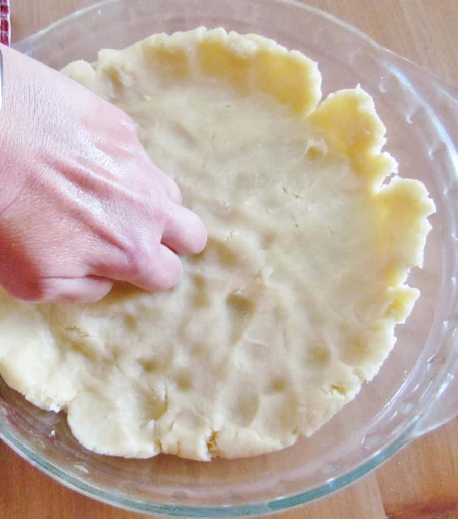 knuckles pressing down on the pie crust to get it to flatten out.
