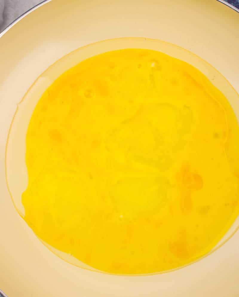 beaten eggs in a skillet with oil.