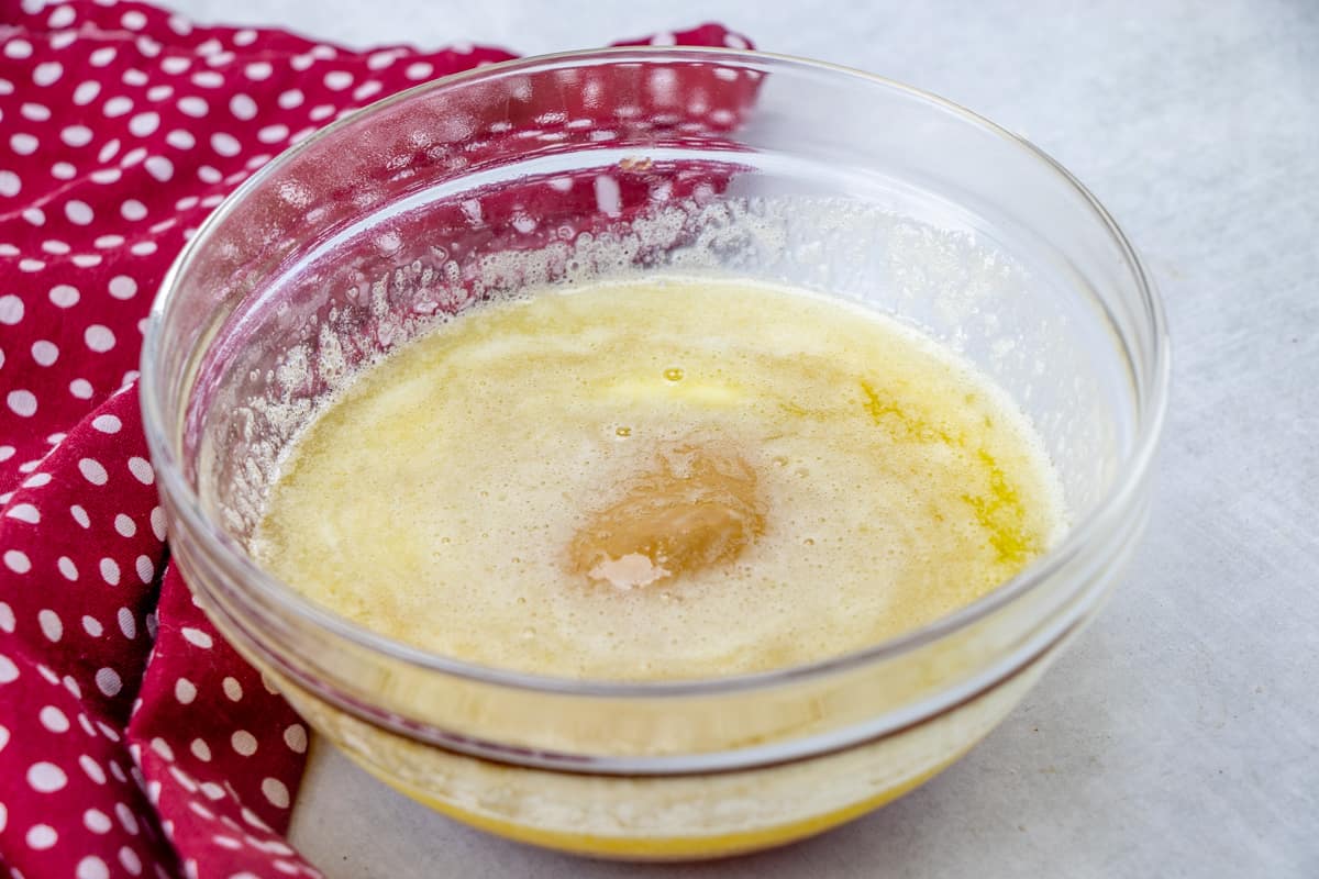 melted butter, peanut butter and honey in a clear glass bowl