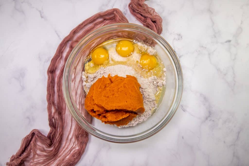 pumpkin puree, eggs and spice cake mix in a large, clear mixing bowl