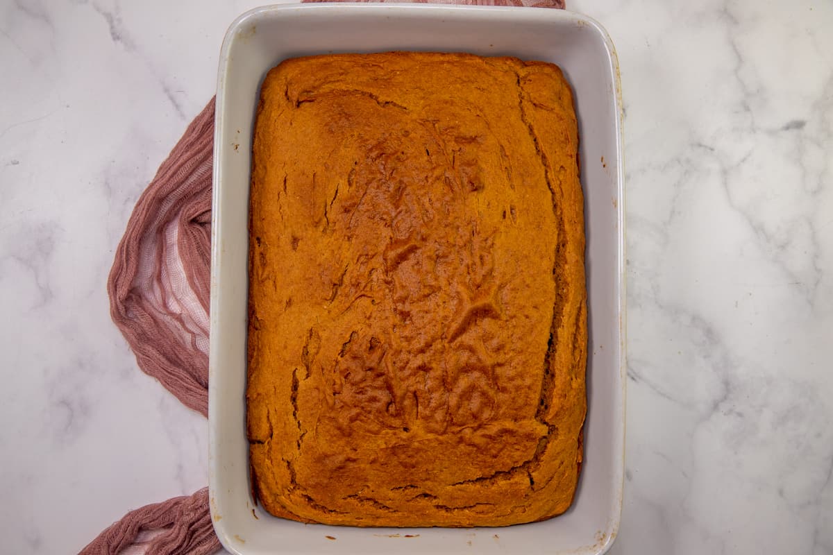 fully baked pumpkin spice cake in a white baking dish.