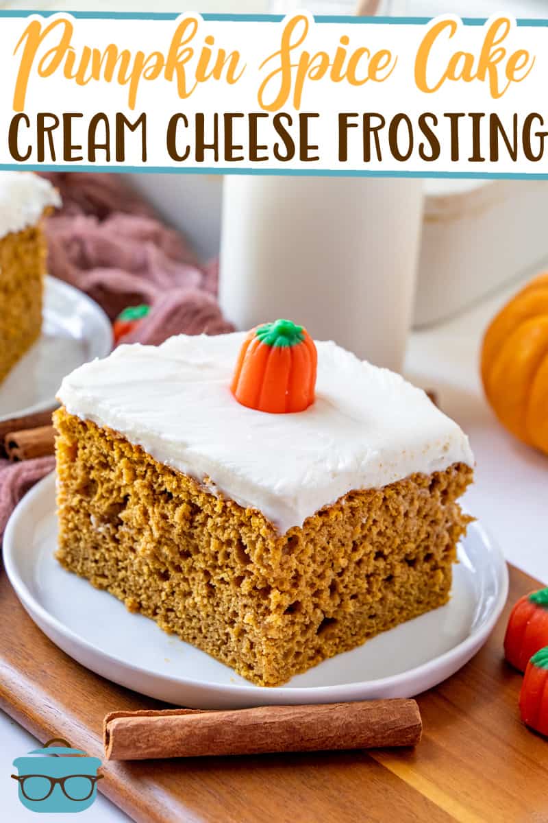 Pumpkin Spice Cake with Cream Cheese Frosting recipe from The Country Cook, slice shown on a small white plate and topped with a candy pumpkin.
