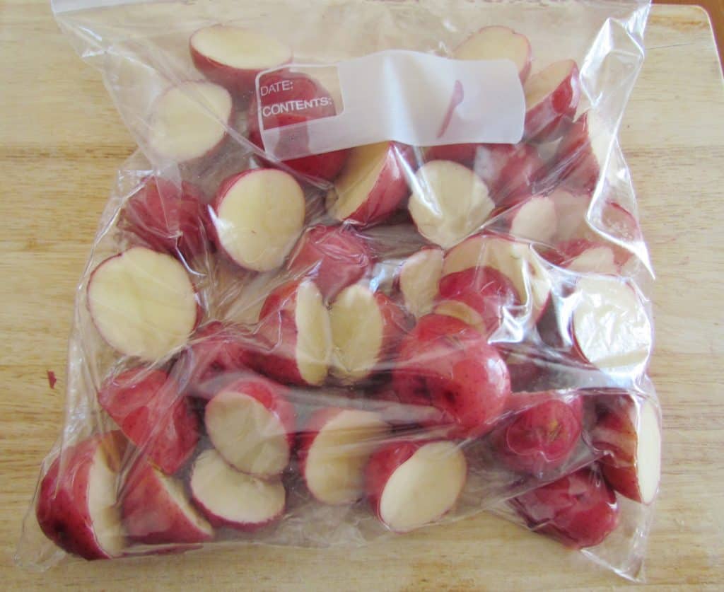 oil covered sliced potatoes in a bag