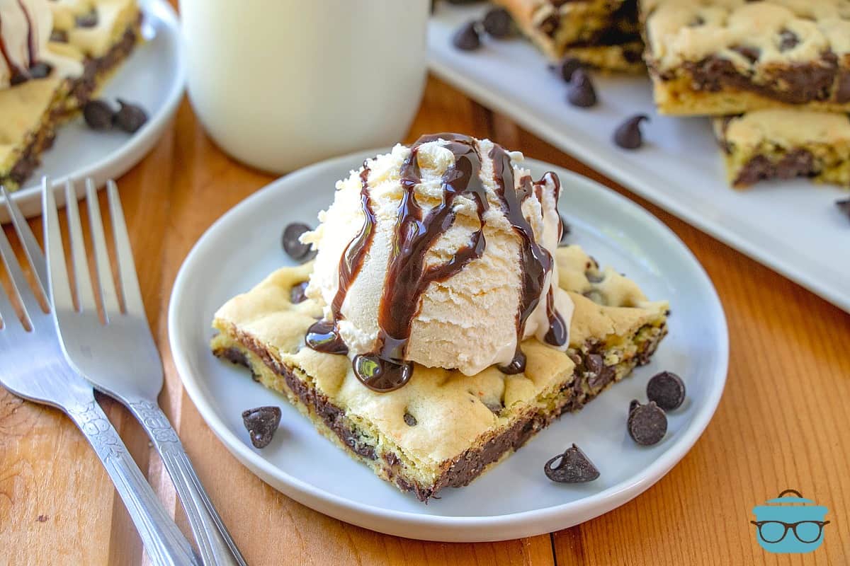 slice, Cake Mix Chocolate Chip Cookie Bar on a plate topped with ice cream.