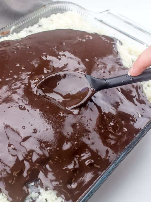 chocolate sauce spread on cake with the back of a spoon.
