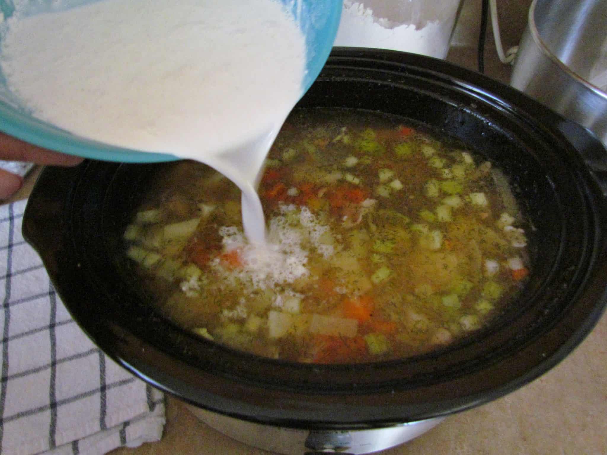 adding half and half into potato leek soup.