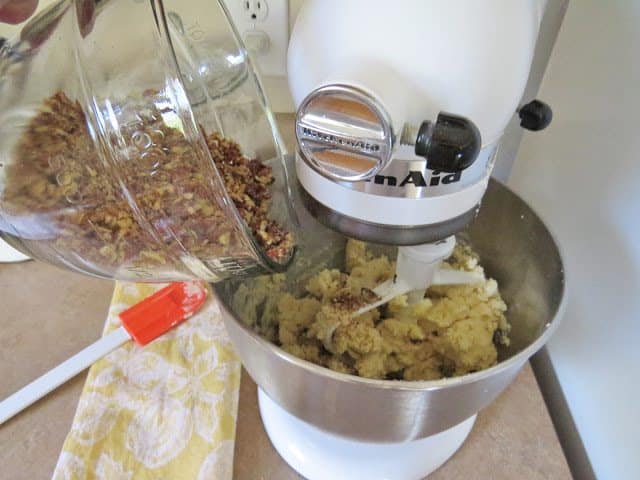 adding chopped pecans to shortbread cookie batter.