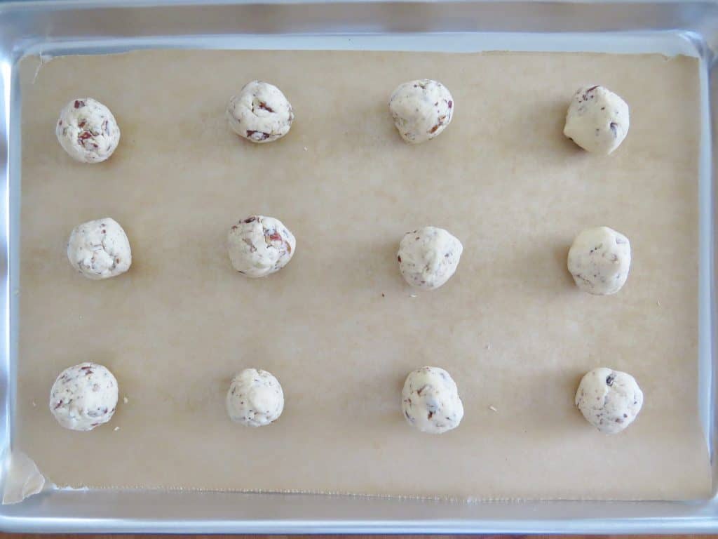 shortbread cookie balls on a parchment paper lined baking sheet