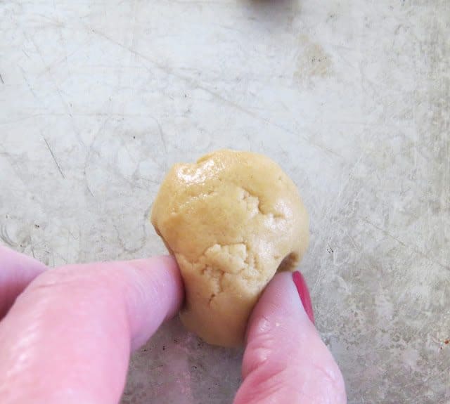 closeup photo of hand shaping the cookie dough ball.