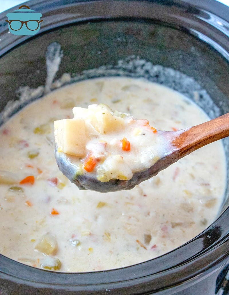 spoonful, Crock Pot Leek and Potato Soup, fully cooked, in an oval slow cooker.