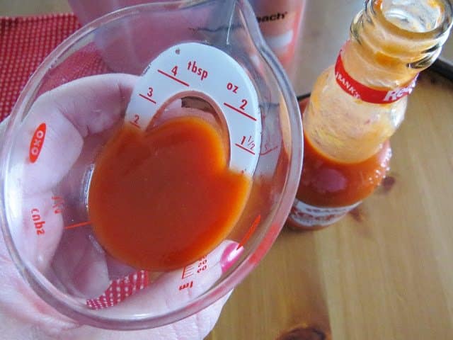 buffalo wing sauce in a small measuring cup.