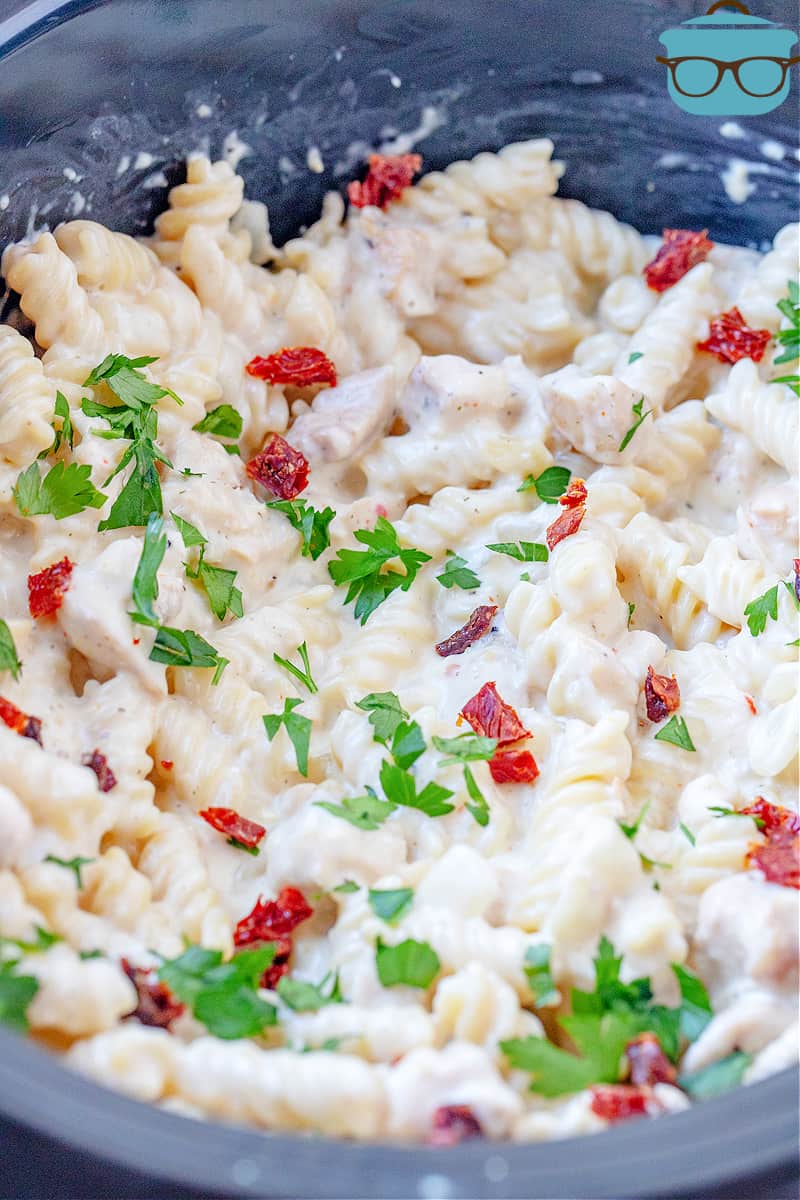 closeup of fully cooked creamy Italian chicken pasta inside slow cooker.