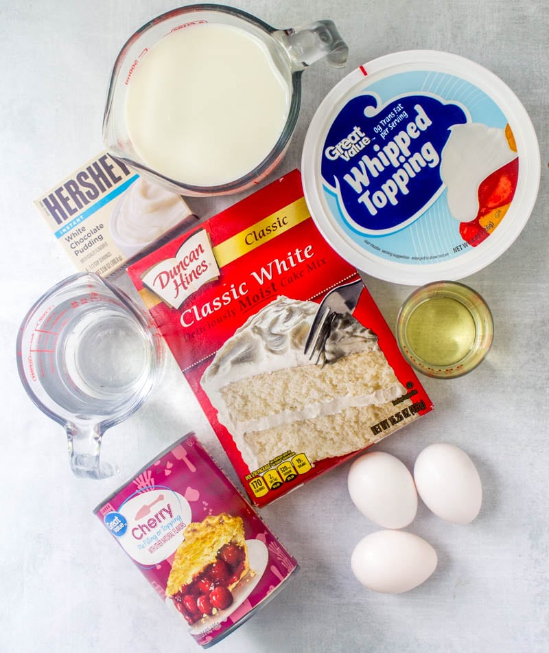 Duncan Hines White Cake Mix, whipped topping (Cool Whip), cherry pie filling, egg whites, Hershey's White Chocolate Pudding, milk