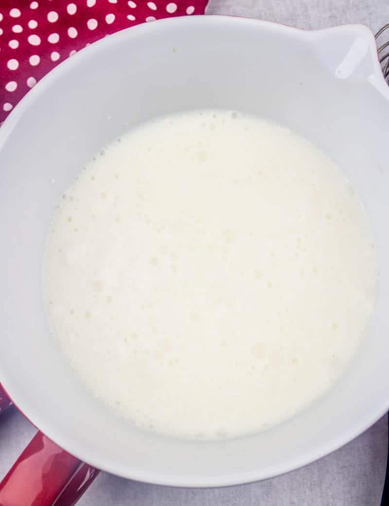 white chocolate pudding mixed with cold milk in a white bowl.