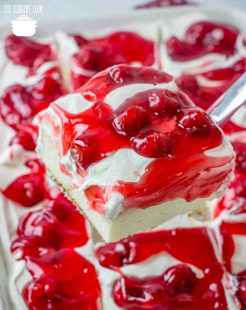 Cherries in the Snow Pudding Poke Cake, slice removed from baking dish
