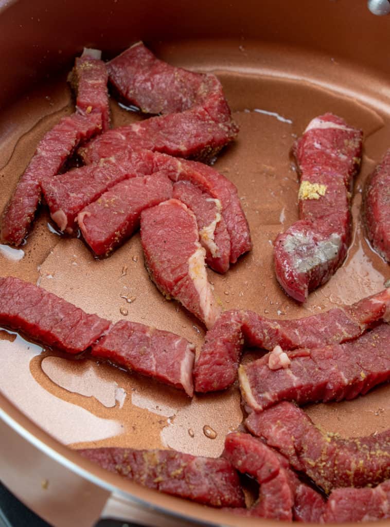 browning fajita beef strips in a pan