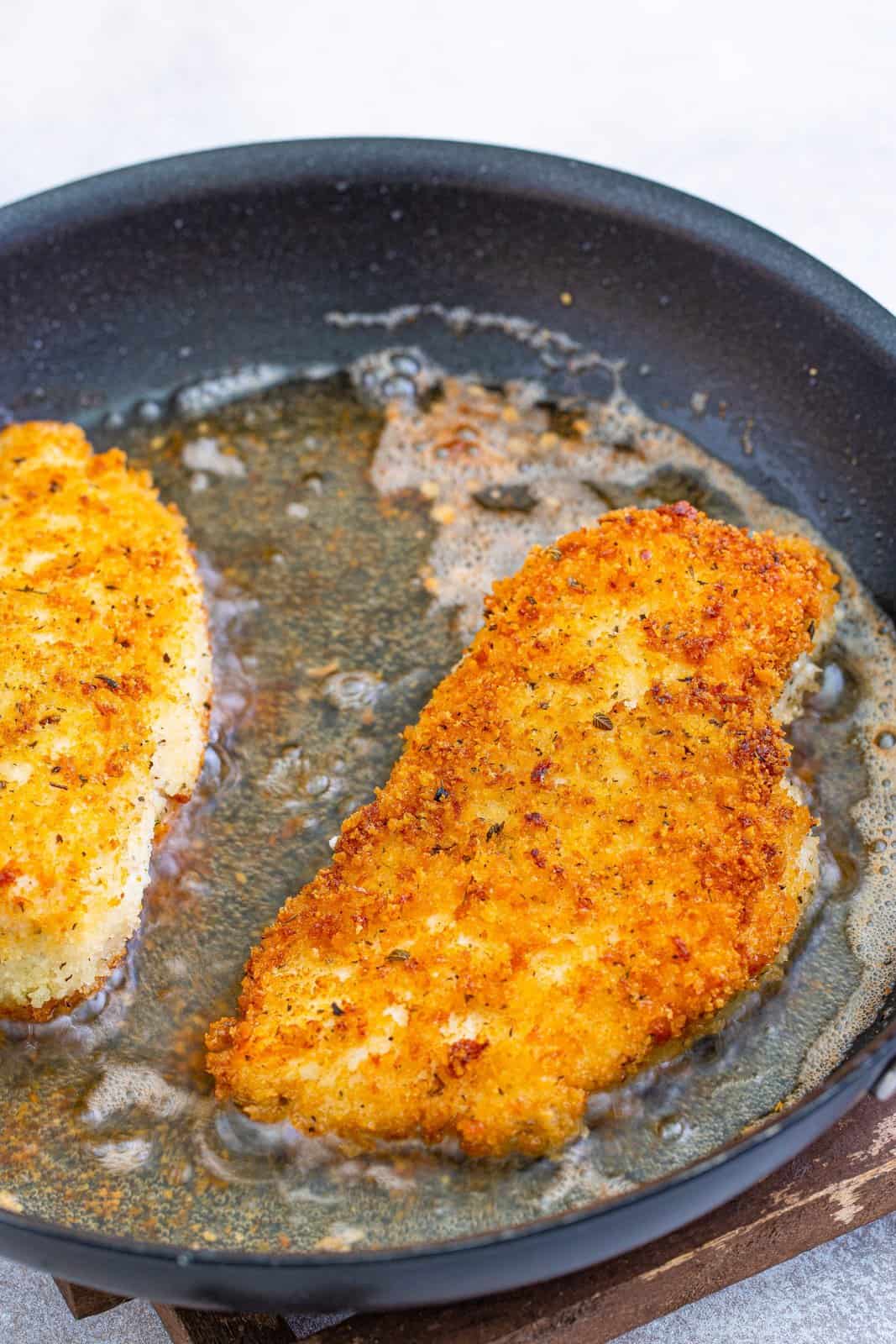 browning chicken breasts in a skillet.