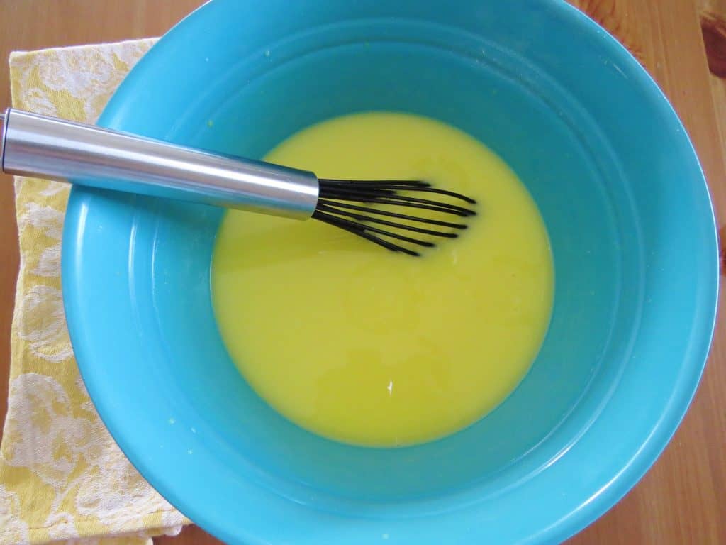 WHISKING LEMON PUDDING MIX TOGETHER IN A BOWL