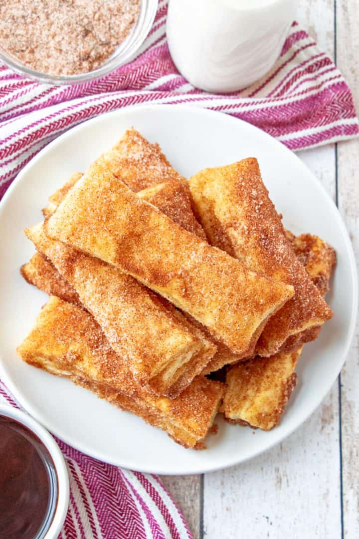 stacked cinnamon sugar puff pastry on a white plate.