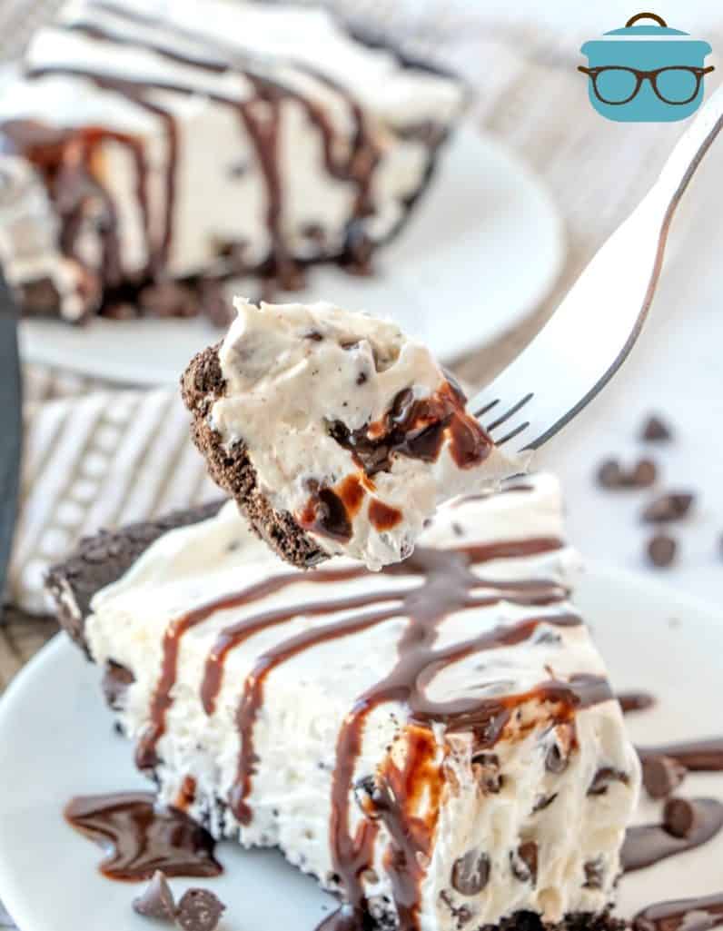 slice, No Bake Chocolate Chip Cheesecake drizzled with chocolate syrup
