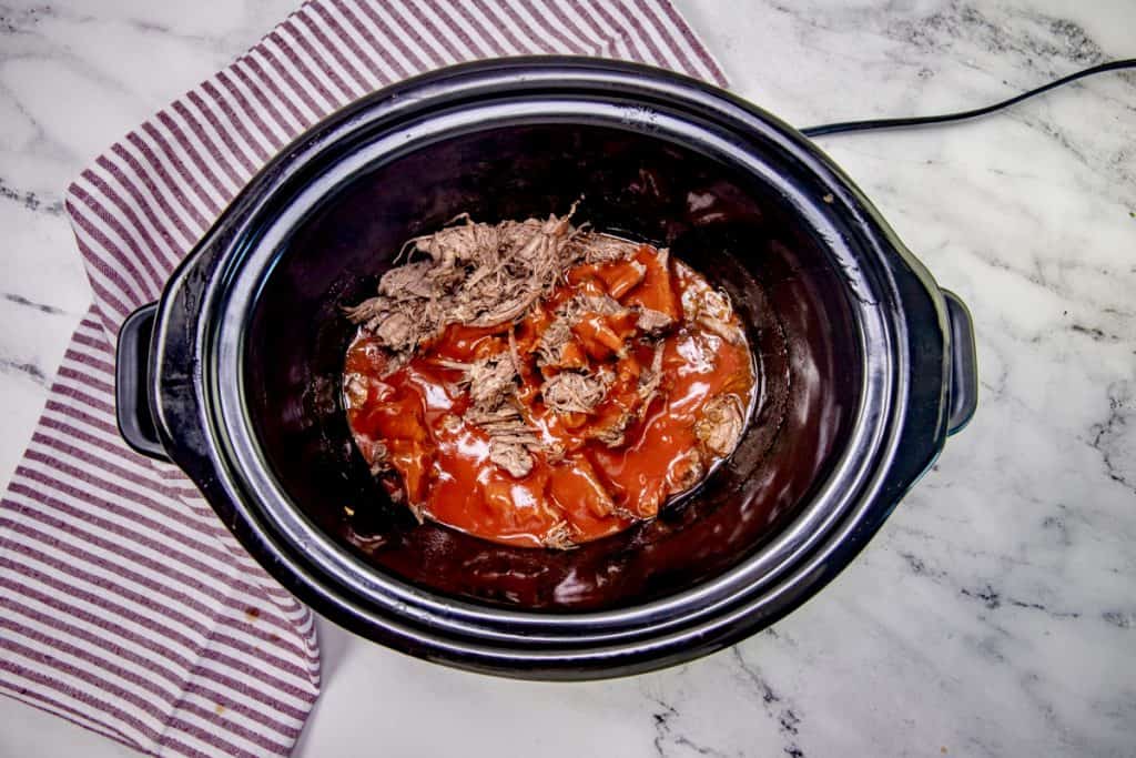 taco sauce added to shredded and cooked chuck roast