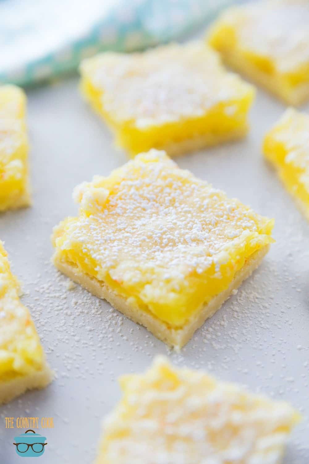 Easy 3-Ingredient Lemon Crumble Bars, sliced, on parchment paper.