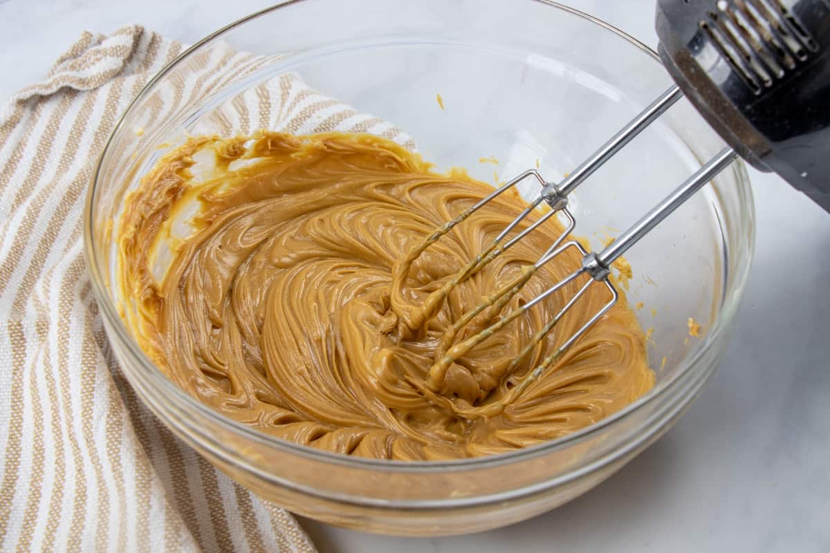 peanut butter and margarine mixed together using a handheld electric mixer.